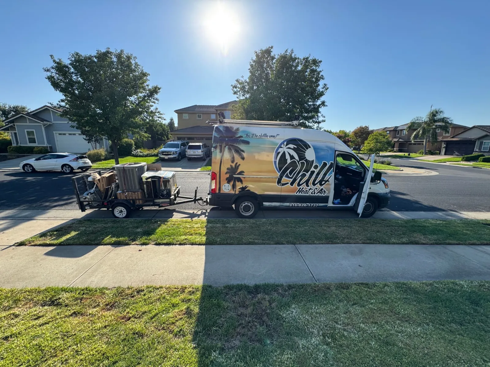 Chill Heating & Air van and equipment trailer parked on a Roseville street