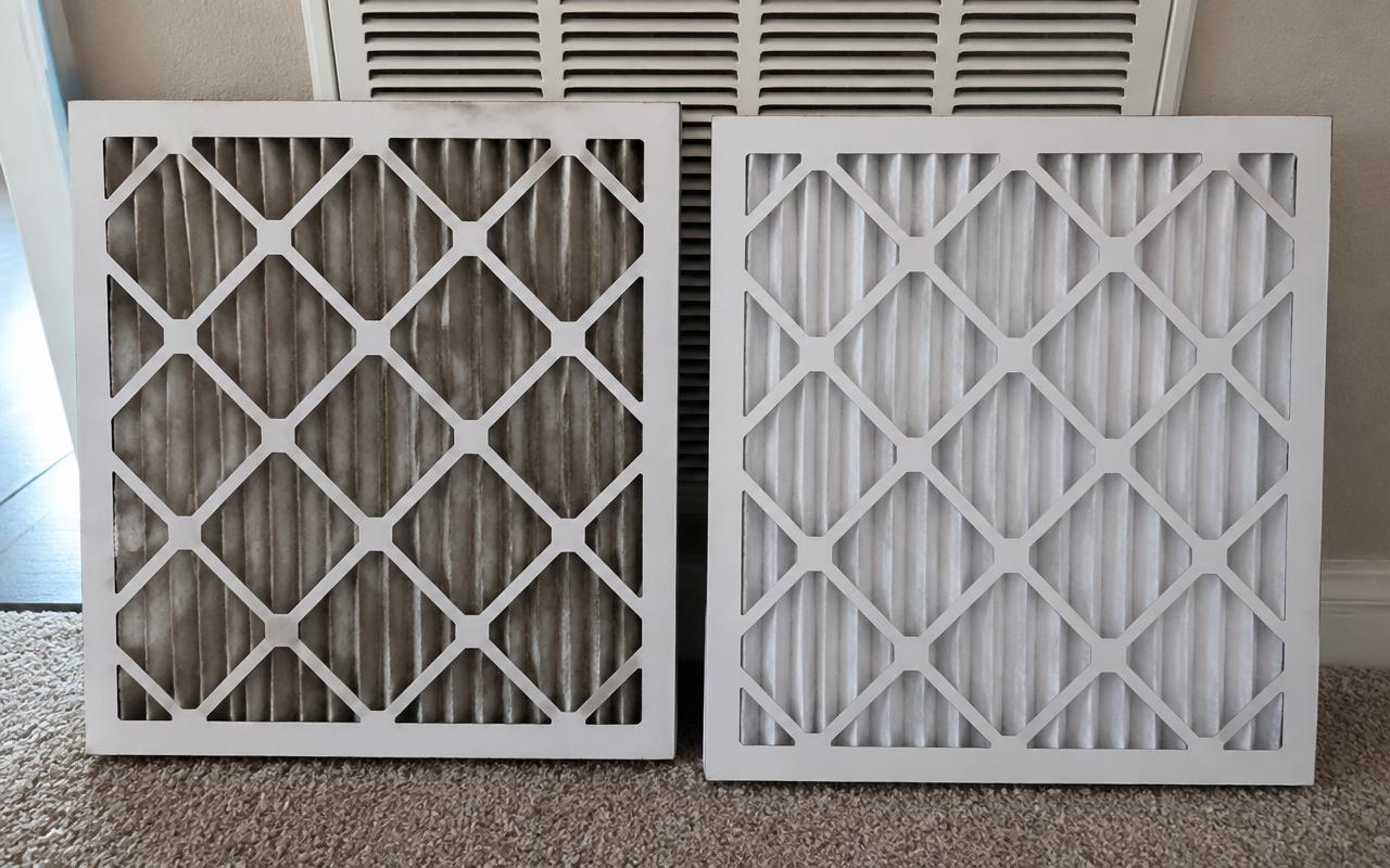 Dirty air filter next to a clean replacement filter